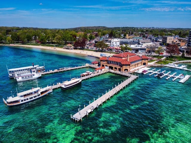 The Riviera pier and boathouse on clear green water in Lake Geneva